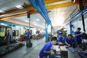 Factory floor with machines and overhead cranes