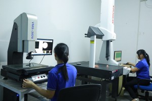 Technicians inspecting parts with measurement tools